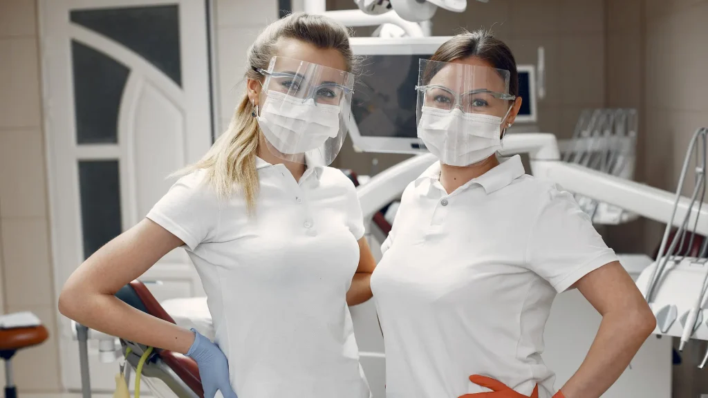 doctors-in-special-uniform-dentists-wear-protective-masks-girls-look-at-the-camera-e1603979249277